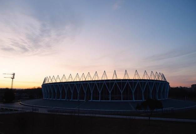 a stadium with a clear sky and a few clouds in the background