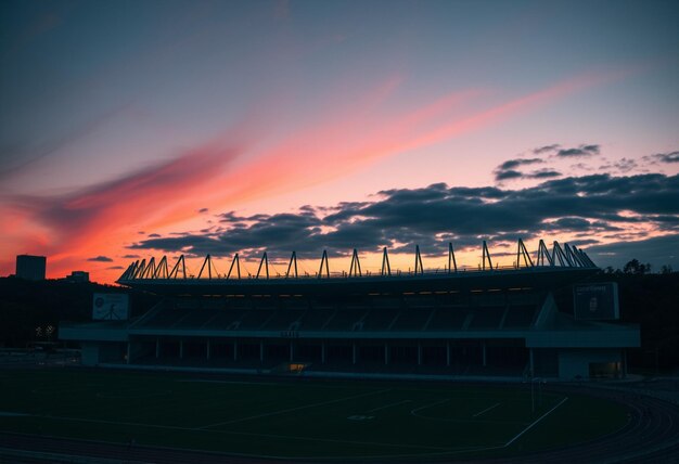 Photo a stadium with the sun setting behind it