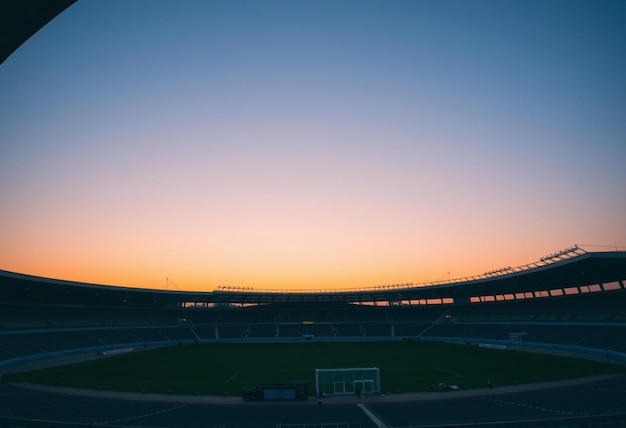 a stadium with a sunset in the background