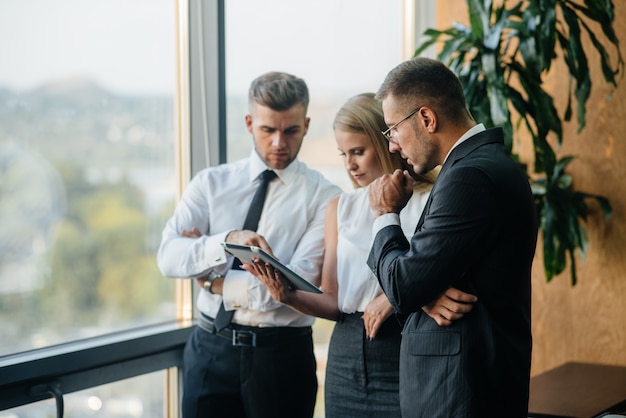 The staff in the office to discuss business matters next to the window. Business, Finance