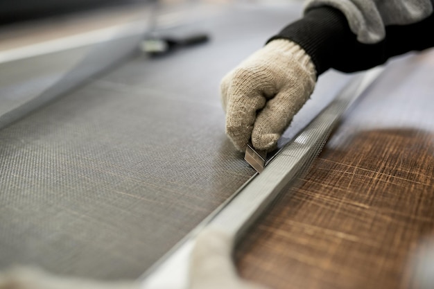 The stage of assembling the mosquito net in the factory for the PVC plastic window closeup