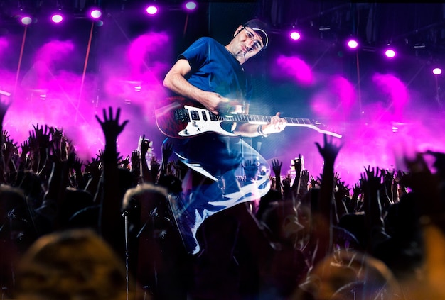 Stage lightsAbstract musical backgroundPlaying guitar and concert concept