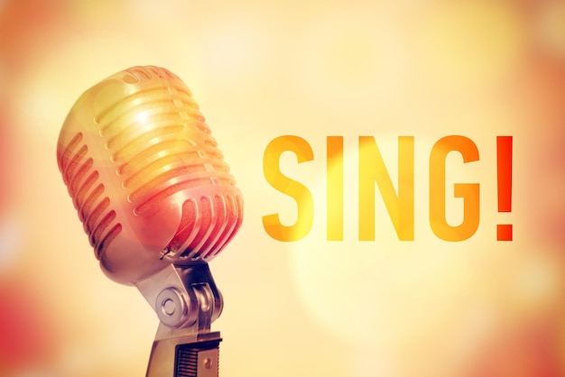 Stage microphone on a glowing abstract background with an inscription Sing Toned