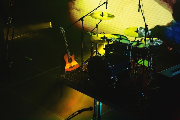 Stage with musical instruments drum set and acoustic guitar