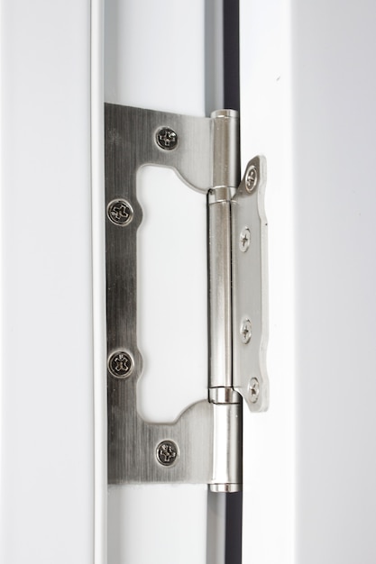 Stainless door hinges on a white door. Hinges on the white door.