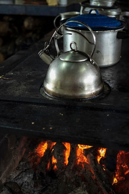 Stainless steel kettle on a wood stove