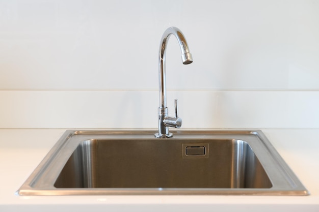 Stainless steel kitchen sink in room