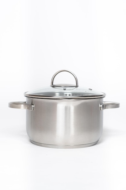 Stainless steel pot with glass lid and drain spout on a white background