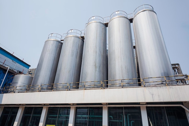 Stainless vertical steel tanks with equipment tank chemical cellar at the with stainless steel silo