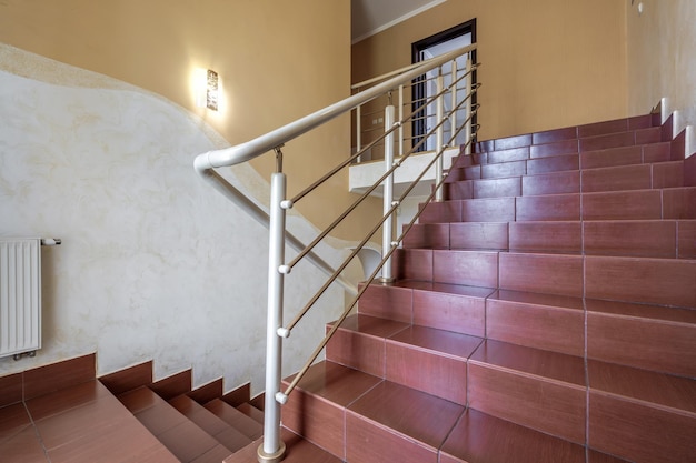 Stairs emergency and evacuation exit in up ladder in old house or building