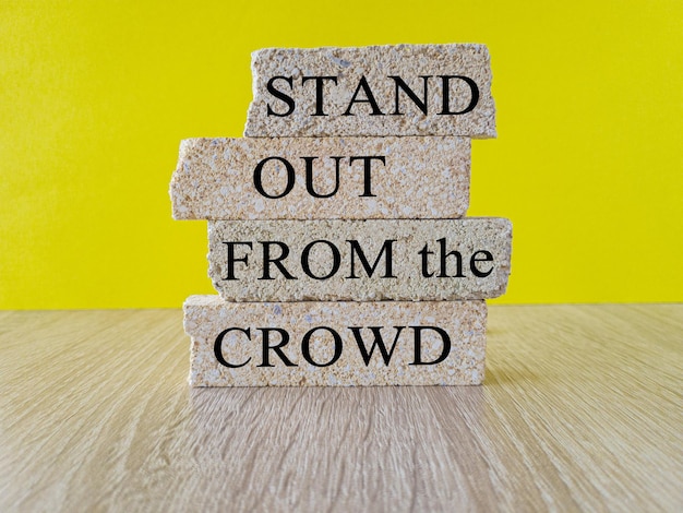 Stand out from the crowd symbol Concept words Stand out from the crowd on brick blocks