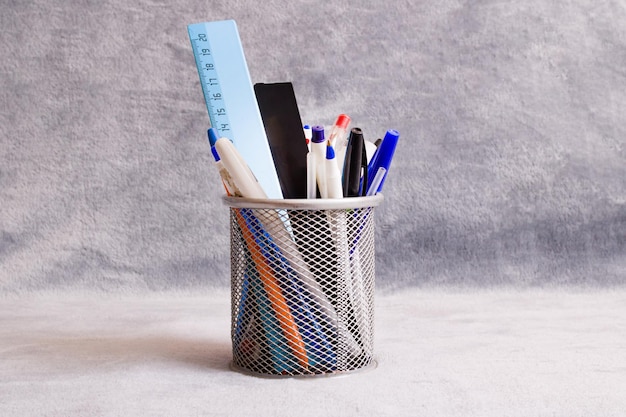 Stand with pens on a gray background