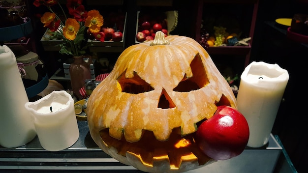 Standard symbol of Halloween Jack lantern Scary head of pumpkin bites red apple Festive decoration