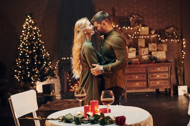 Standing and dancing Young lovely couple have romantic dinner indoors together