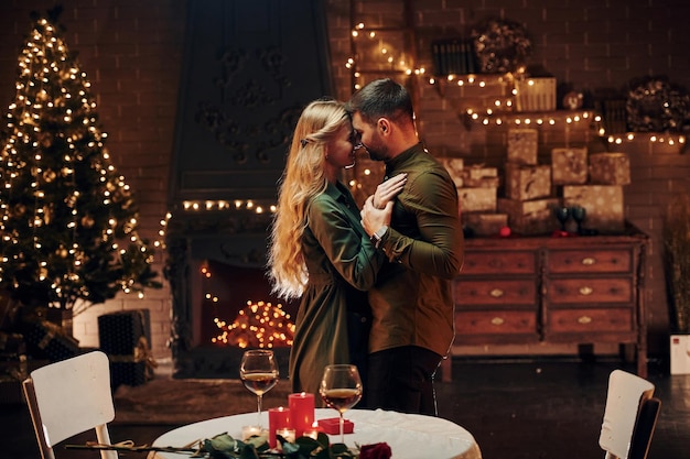 Standing and dancing Young lovely couple have romantic dinner indoors together