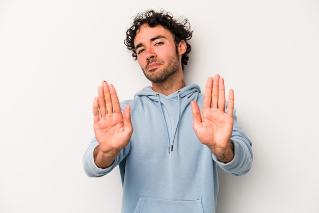 Standing with outstretched hand showing stop sign preventing you