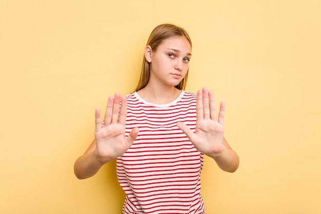 Standing with outstretched hand showing stop sign preventing you