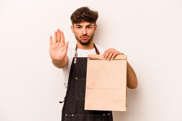 Standing with outstretched hand showing stop sign preventing you