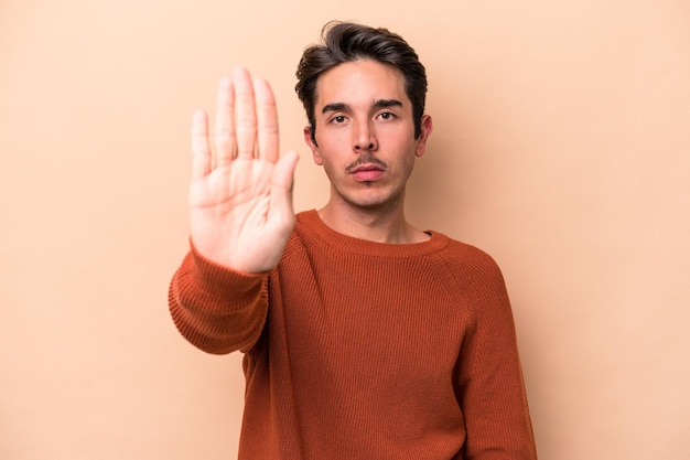 Standing with outstretched hand showing stop sign preventing you