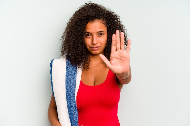 Standing with outstretched hand showing stop sign preventing you