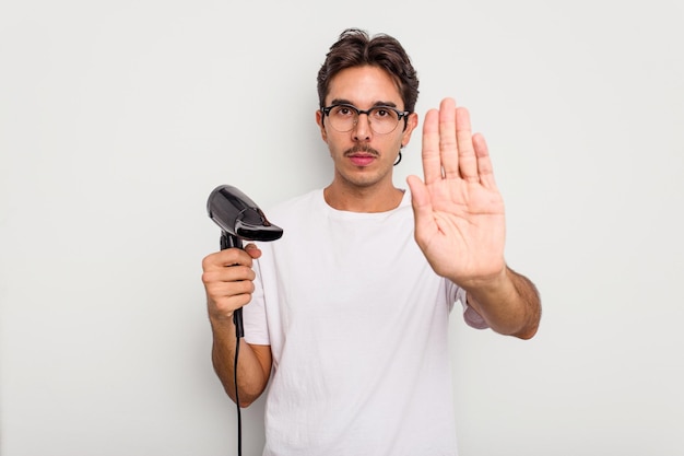 Standing with outstretched hand showing stop sign preventing you