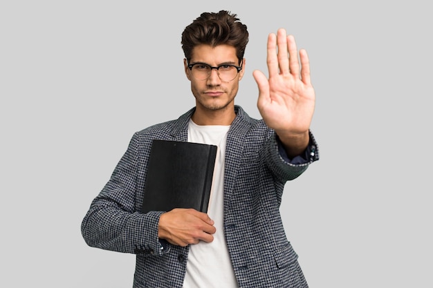 Standing with outstretched hand showing stop sign preventing you