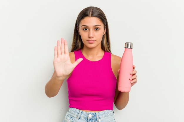 Standing with outstretched hand showing stop sign preventing you