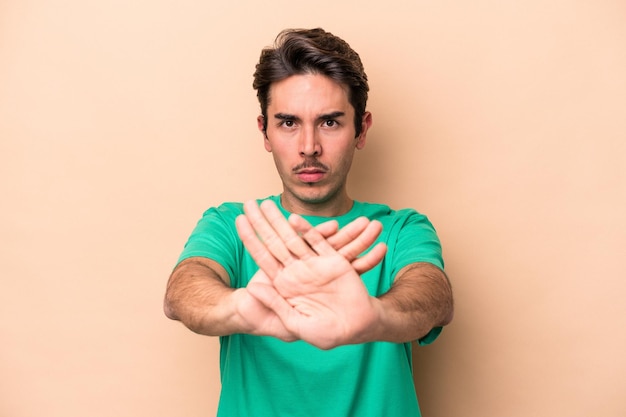 Standing with outstretched hand showing stop sign preventing you