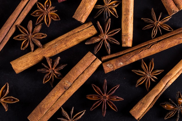 Star anise and cinnamon on a black table. , copyspace.