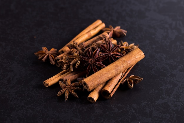 Star anise and cinnamon on a black table. , copyspace.