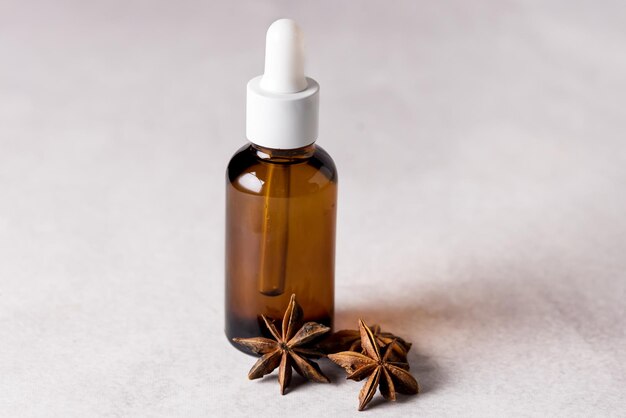 Star Anise Essential Oil on Bottle on Gray Background Alternative Medicine Horizontal