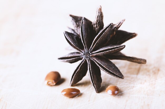 Star anise with seeds on old wooden table close-up with copyspace.