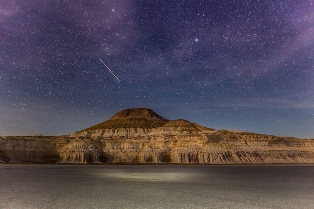 A star falls. The Ustyurt Plateau. District of Boszhir. The bottom of a dry ocean Tethys. Rocky remnants. Kazakhstan. long shutter speed