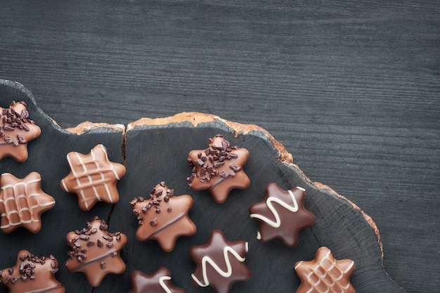 Star-shaped chocolates on dark textured background, copy-space