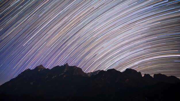 Star trails over Doi Luang Chiang Dao mountain at night,Thailand