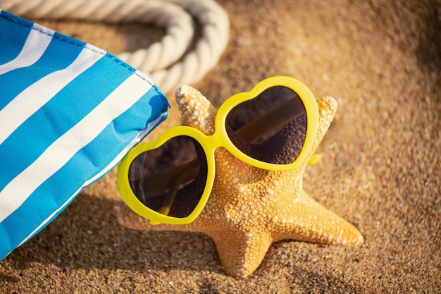 Starfish wearing sunglasses on the beach