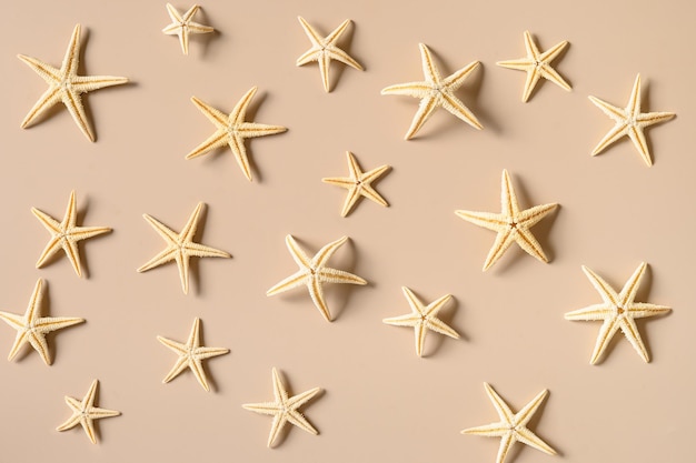 Starfishes on beige background as sand Summer beach vacation