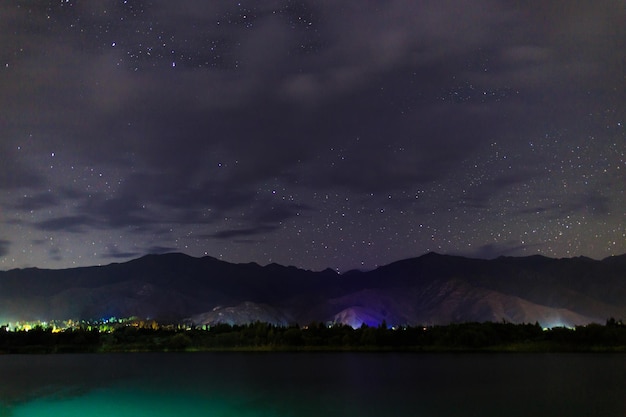 Starry sky on the lake Night landscape Sky with clouds Kyrgyzstan Lake IssykKul