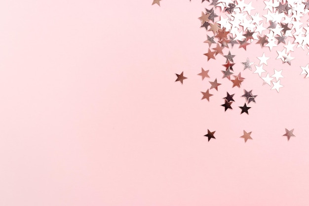 Stars glitter scattered on pink pastel background Monochromatic concept