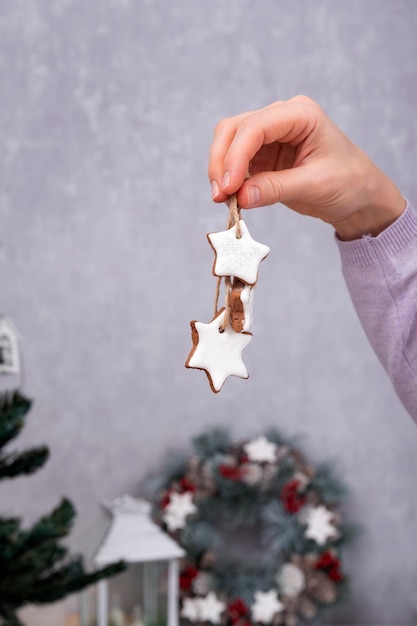 Starshapes cookies for Christmas decoration Christmas baked goods in female hand