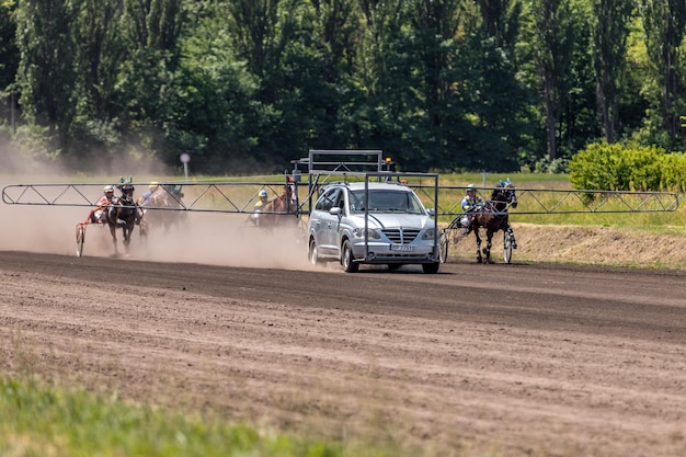 Starting machine on the racetrack Start of the trotting horse race The start of the competition