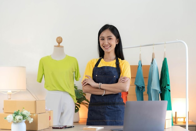 Startup small business entrepreneur SME asian woman packing cloth in box Portrait young Asian small business owner home office online sell marketing delivery SME ecommerce telemarketing concept