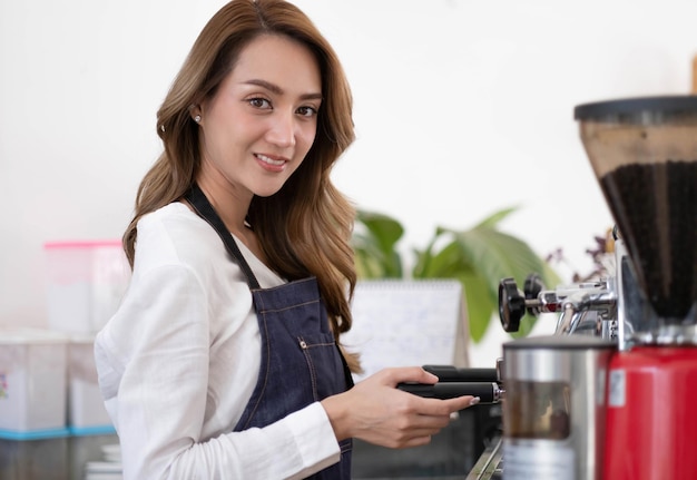 Startup successful small business owner sme beauty girl stand with tablet smartphone in coffee shop restaurant Portrait of asian tan woman barista cafe owner SME entrepreneur seller business concept