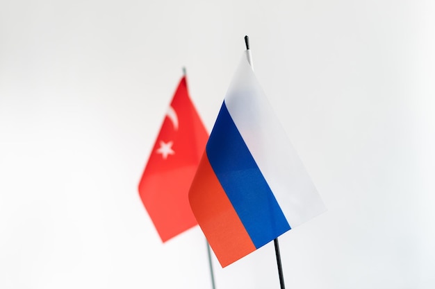 State flags of Russia and Turkey on white background Selective focus on russian flag