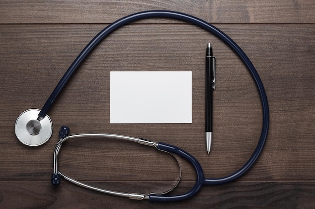 Statoscope and notebook with ball pen on wooden table