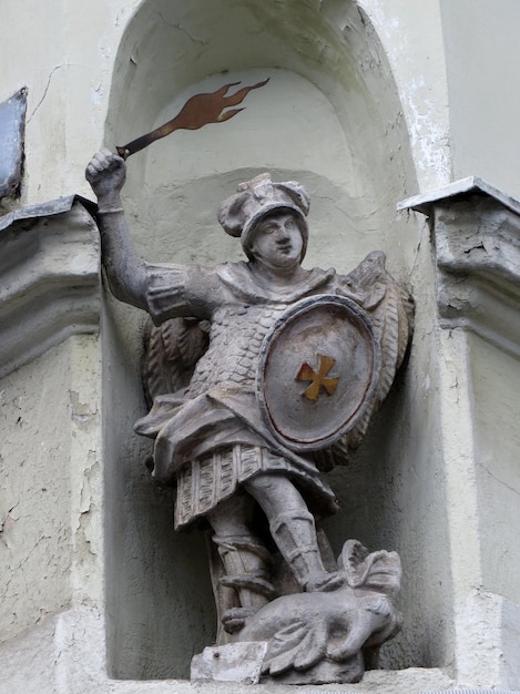 Statue of the angel Saint George with wings behind his back and the flaming sword