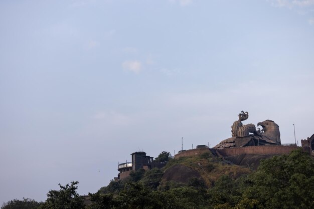 A statue of a bull on a hill