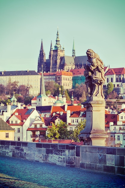 Statue on Charles Brigde against St Vitus Cathedral in Prague