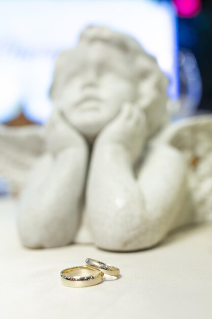 a statue of a man and a diamond ring with a statue of a woman