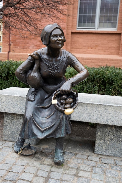 Statue of tradeswoman at New Town Market Square in Torun